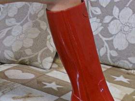 Christina in a red rubber swimsuit and rubber boots