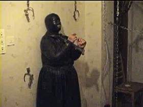 Rubber slave in chains and iron