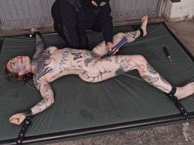 Tattoo model fisted on the mattress