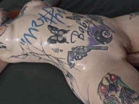Tattoo model fisted on the mattress
