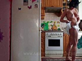 Natalia in a diaper in the kitchen