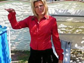 With satin blouse, nylons and mini skirt in the pool