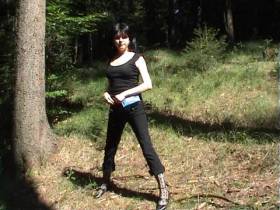 Beautiful woman peeing in the woods