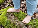 Bare feet in the mud, leaves and moss
