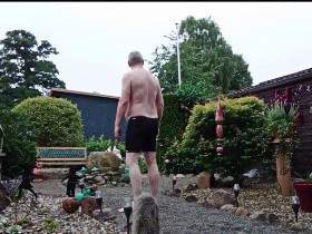 Fat man in the front yard 1 ** swimming trunks **