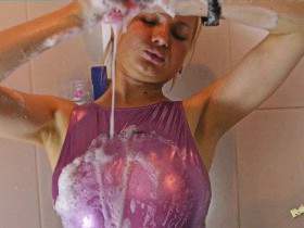 Christina takes a shower in realise rubber swimsuit
