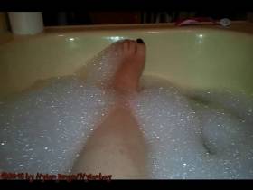 A woman's sexy feet in the tub