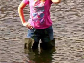 Alina in jeans and waders in deep water