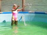 Christina In waders and a pink swimsuit in the pool