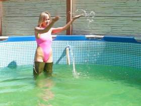 Christina In waders and a pink swimsuit in the pool