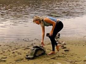 Alina outdoors in Waders and Spandex Leggins walks in a river