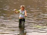 Alina outdoors in Waders and Spandex Leggins walks in a river