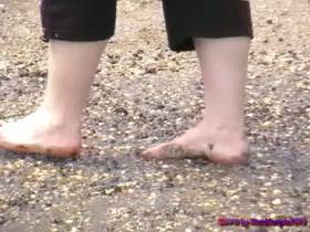 She collects shells on the beach