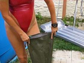 Waders filled with water in a rubber swimsuit