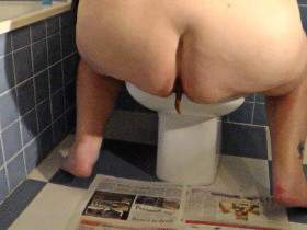 Jen is Shitting on a Newspaper in the Bathroom
