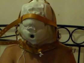 Slut is tied up in mask on the bed