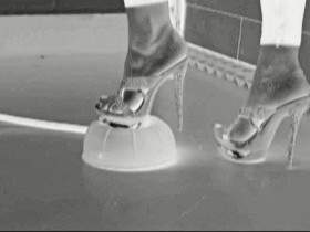 Crushing - heels against beach ball