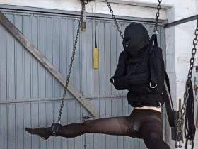 In a straitjacket on the chain hoist