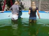 In jeans and waders in pool