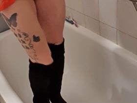 NS in a Christmas outfit and overknee boots over the tub