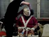 The rubber slave is strapped in her shit filled rubber tights on a wheelchair.