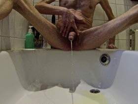 Unshaven cock pisses in shower tray