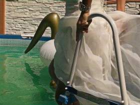 In a wedding dress and fishnet tights in the pool