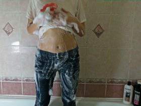 Christina takes a shower in a white T-Shirt and Jeans