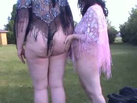 Two lesbians stripping in a park