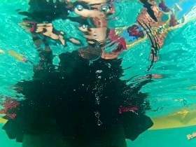 Satin blouse, nylons and mini skirt striptease in the pool - underwater