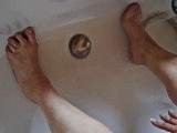 Washing dirty feet in the bathtub