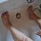 Washing dirty feet in the bathtub