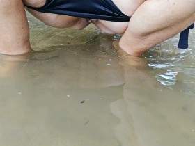 Pissing in the river in a bikini