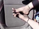 Feet of Nylonjunge in pantyhose in car