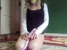 cutie girl in diaper and dummy while play with toys and lollipop