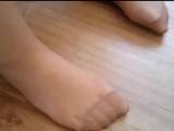Her delicate nylon feet in sandals