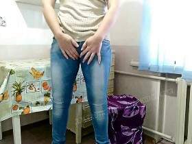 Olga smokes in dirty jeans