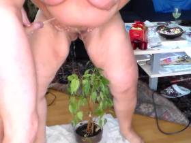 Pissing 53 - She is pissing in a plant and he is pissing on her pussy