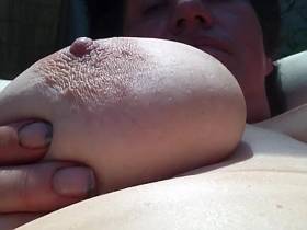 Breasts while sunbathing by the garden in the sun ..... titts