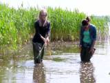 Christina and Jackie walking with Waders in a river