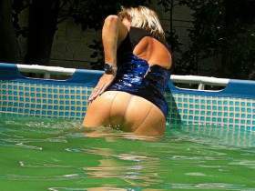In the pool in evening dress and shiny tights