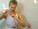 Christina with jeans and white T-Shirt taking a shower