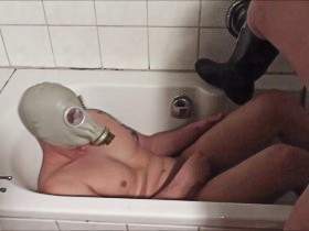 With gas mask peed in the bathtub