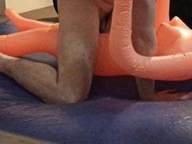 pounding cheap inflatable doll on blue waterbed