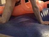 pounding cheap inflatable doll on blue waterbed