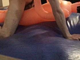 pounding cheap inflatable doll on blue waterbed