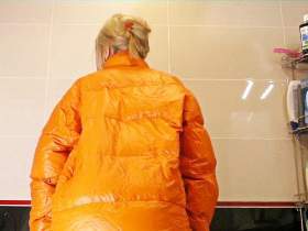 Christina takes a shower in a latex and down jacket