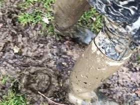 muddy rubber riding boots and wetsuit and cum