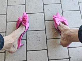 Dangling and shoeplay outdoors with fuchsia mules