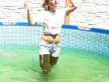In waders with jeans and a wet T-shirt in the pool